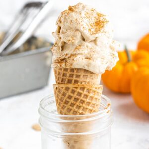 dairy free pumpkin ice cream in a cone with cinnamon on top