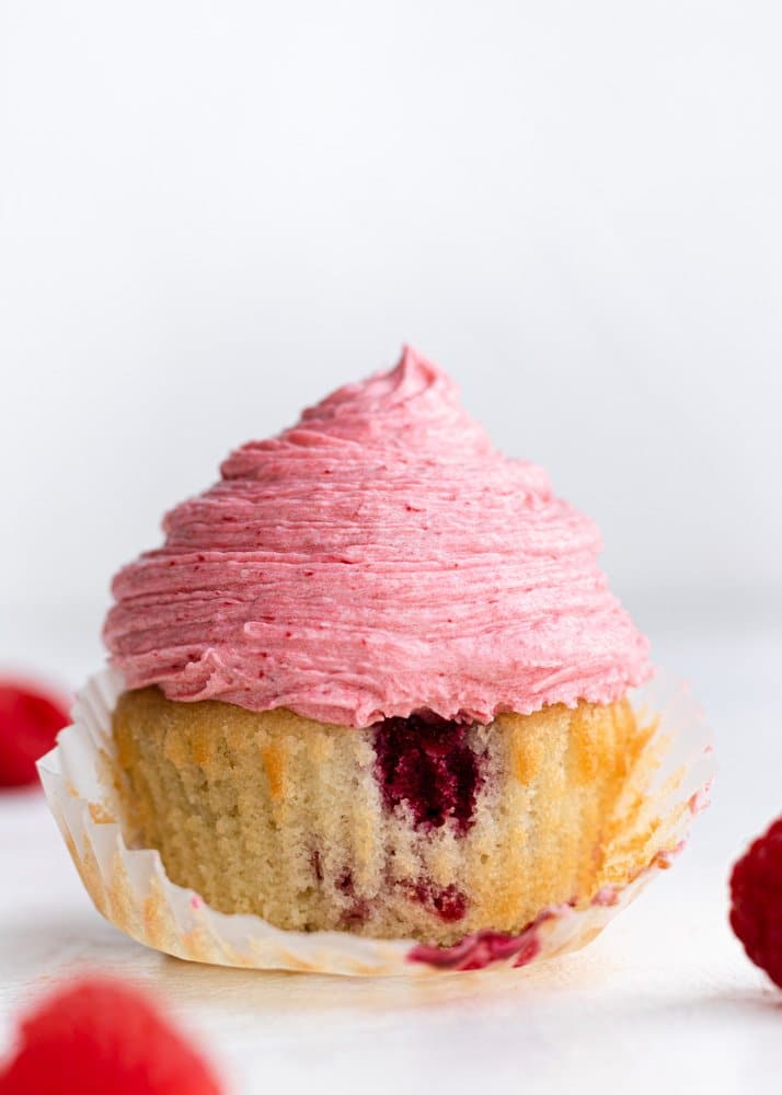 raspberry cupcake with raspberries around it