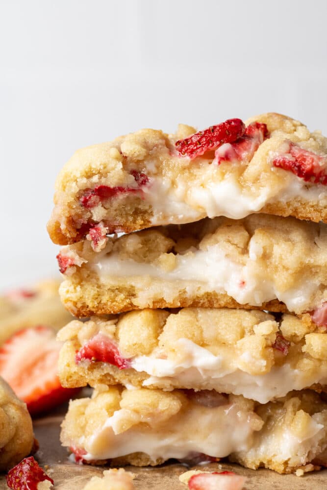 strawberry cheesecake cookies split in half showing the inside of the cookies