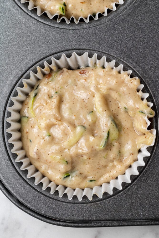 vegan zucchini muffin batter in a muffin tin
