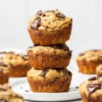 Healthy banana protein muffins with chocolate chips stacked on a plate