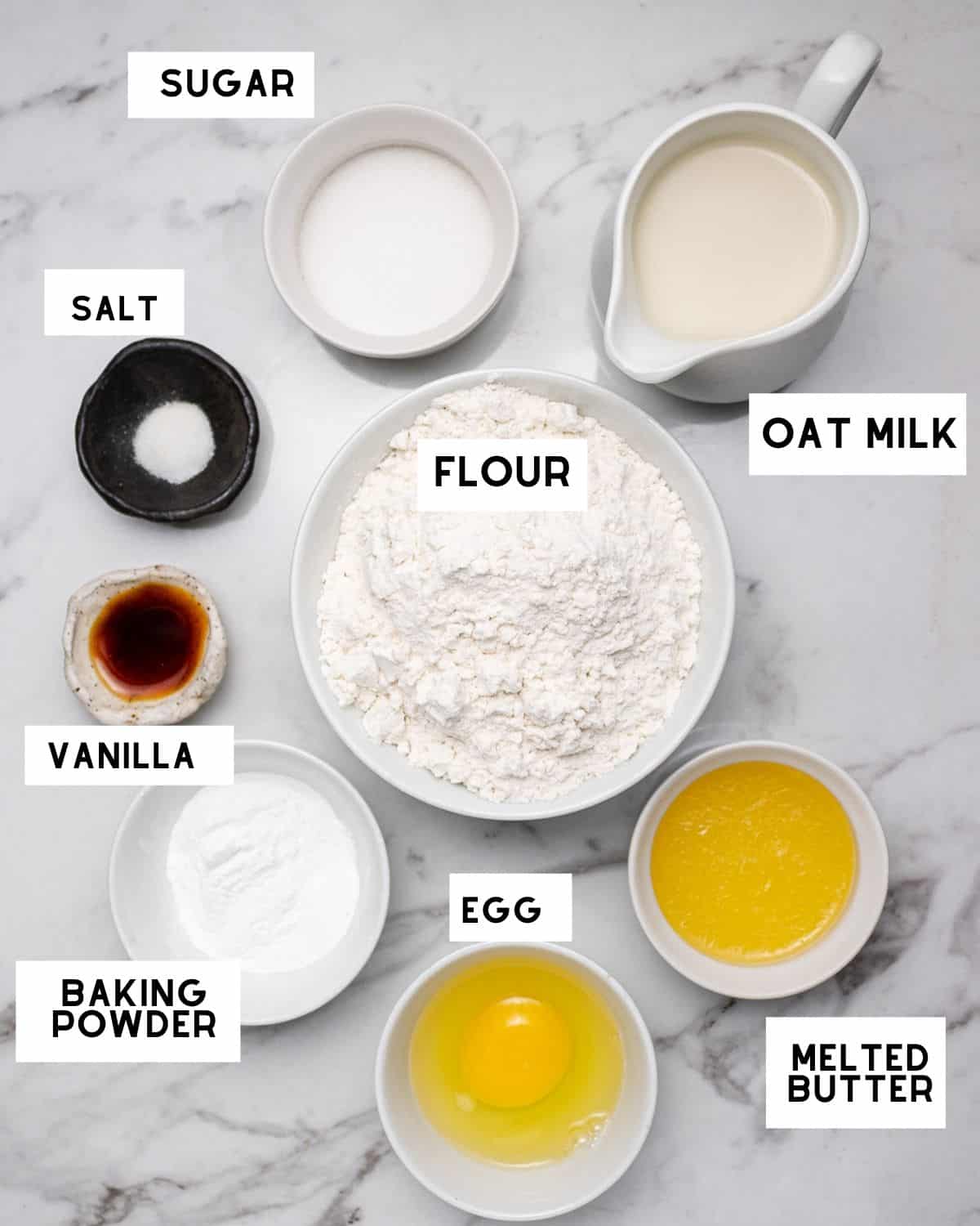 Oat milk pancake ingredients in bowls with labels