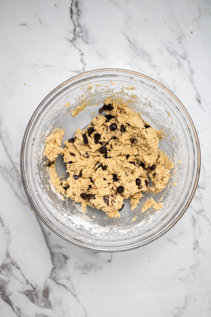 cookie dough mixed together in a glass mixing bowl on a counter