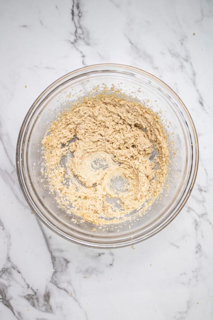 butter and sugar mixed together in a glass mixing bowl
