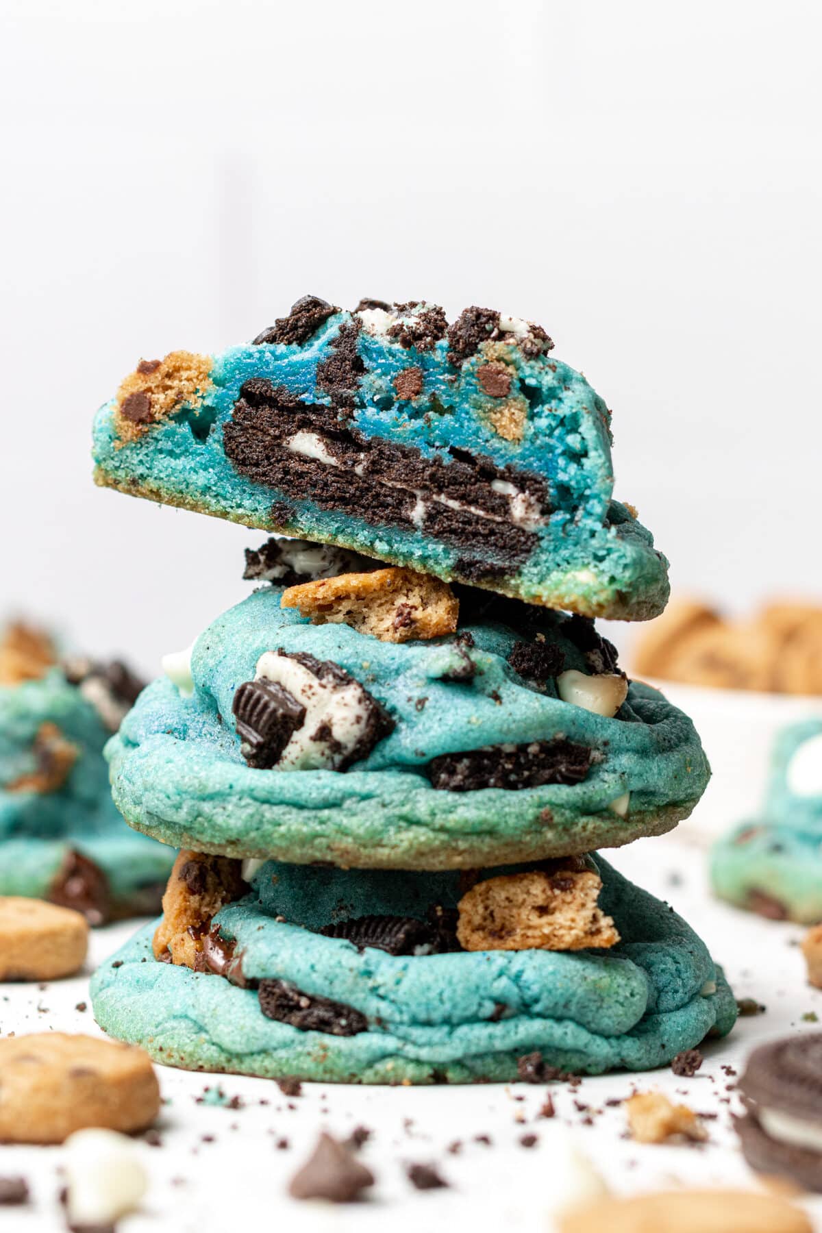 Stacked Cookie Monster Cookies topped cookie is broken in half to see inside filling