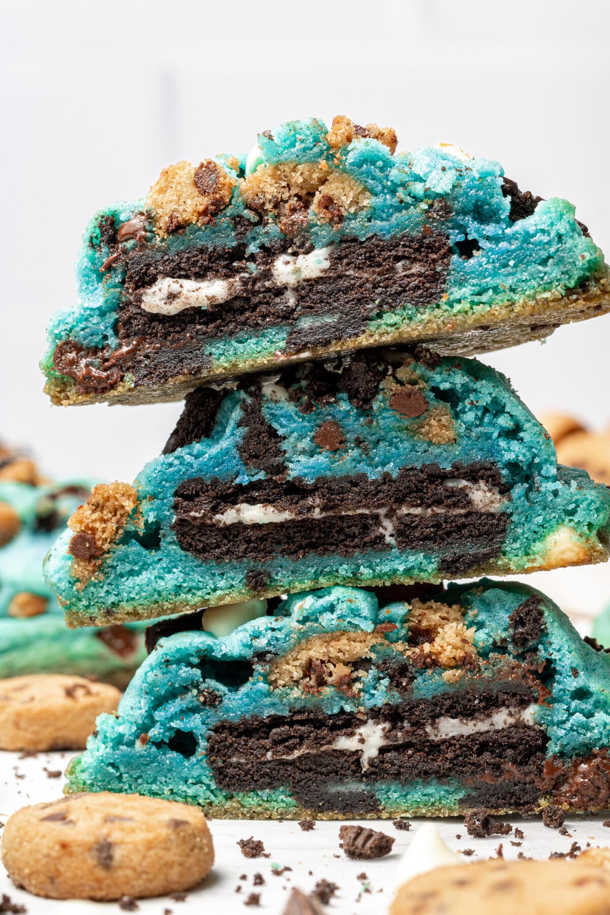 Cookie monster cookies cut in half and stacked mini cookies scattered around