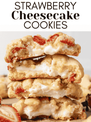 strawberry cheesecake cookies split in half and stacked on top of each other with strawberry pieces around them
