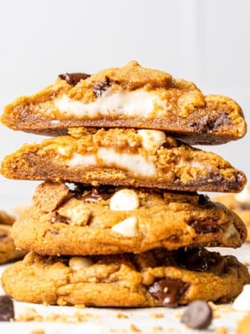Stacked pumpkin cheesecake cookies with chocolate chips scattered around