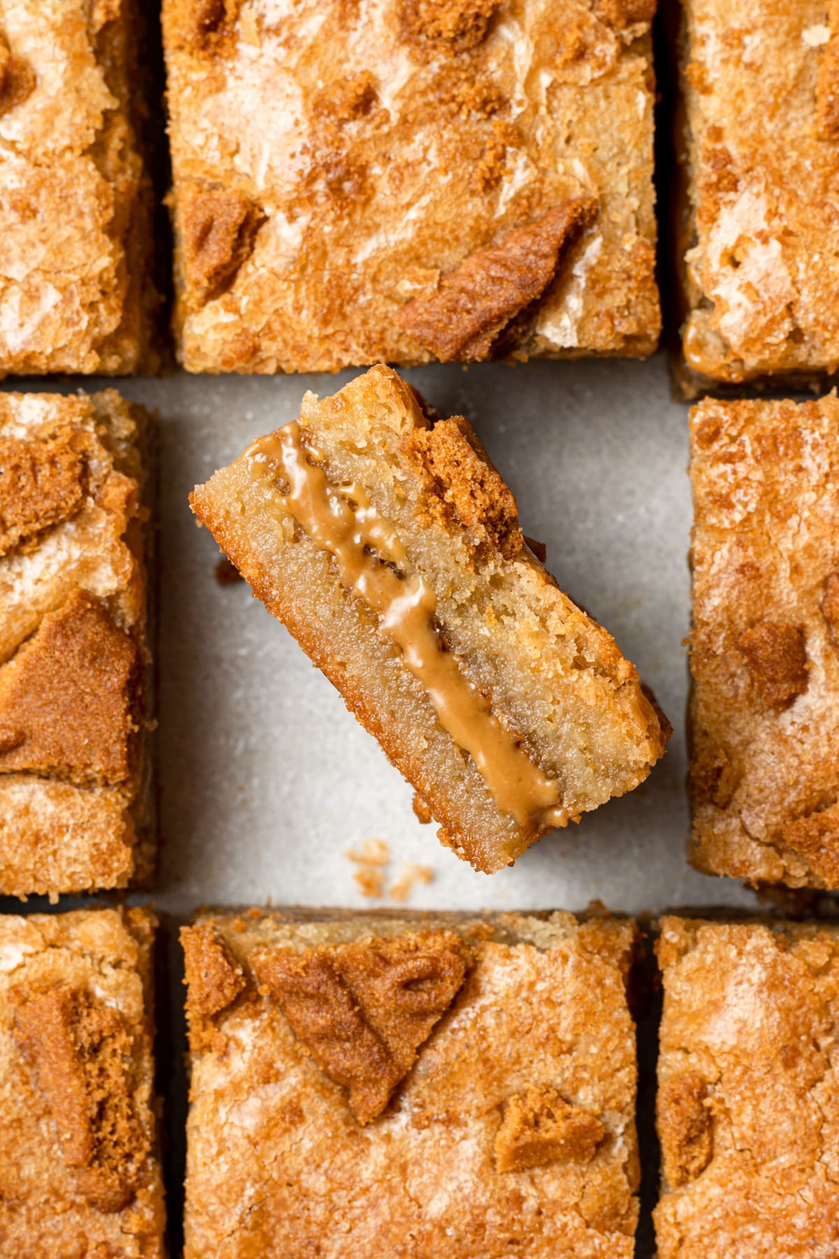 Biscoff blondies cut into squares with center blondie turned on its side to expose blondie filling