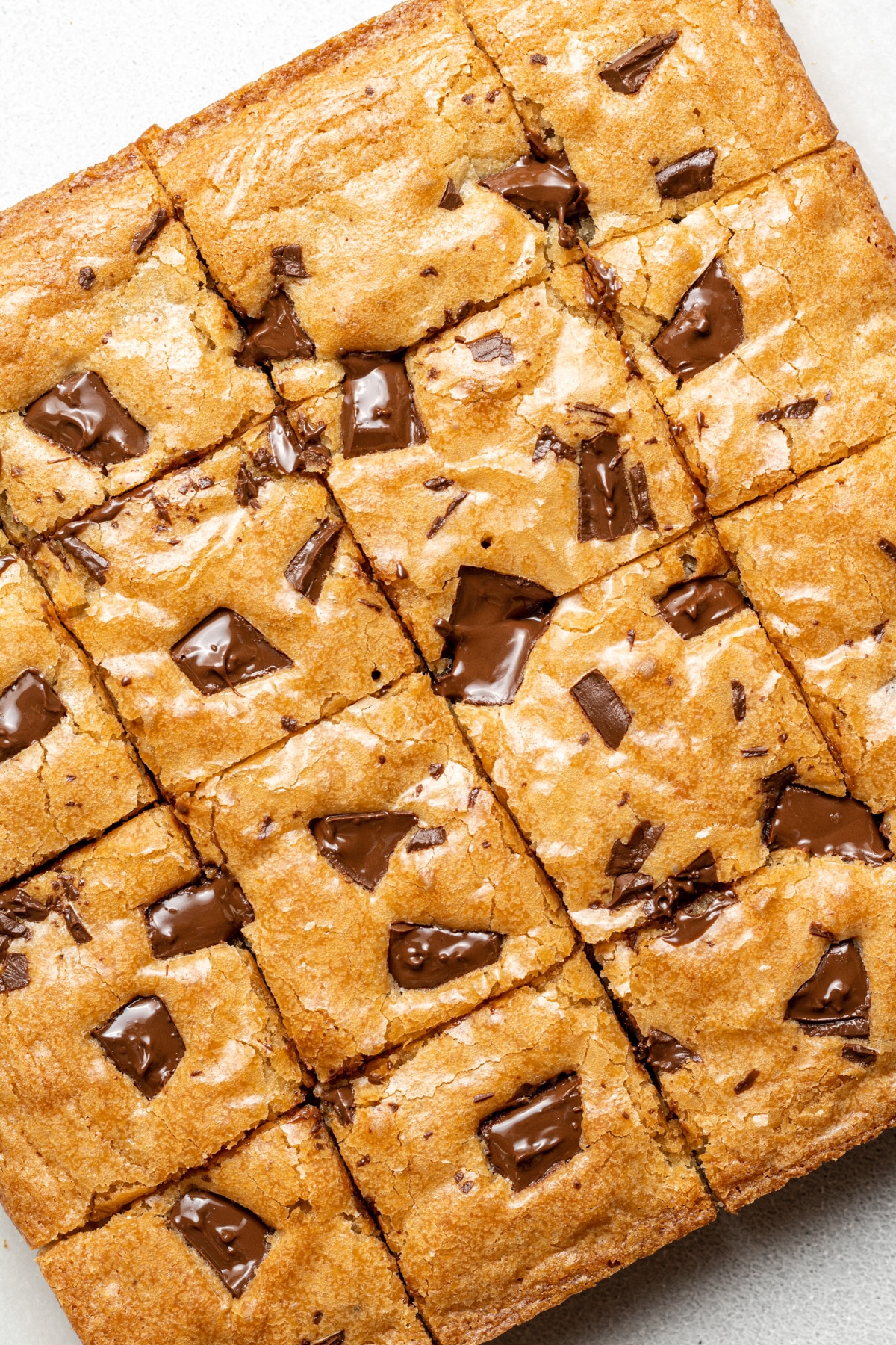blonde brownies sliced into squares on parchment