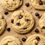 Sheet of eggless chocolate chip cookies with chocolate chips scattered around