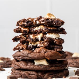 Stacked chocolate marshmallow cookies broken in half exposing the cookie centre