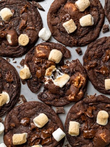 baking sheet with chocolate marshmallow cookies with one cookie split in half