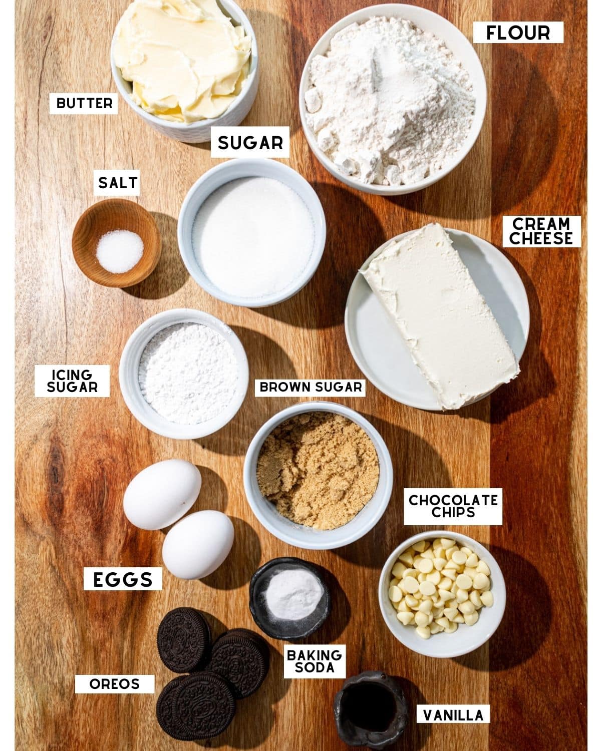 Oreo cheesecake cookie ingredients in bowls with labels