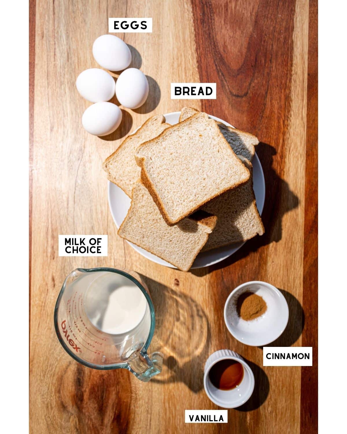 Ingredients for healthy french toast in bowls with labels
