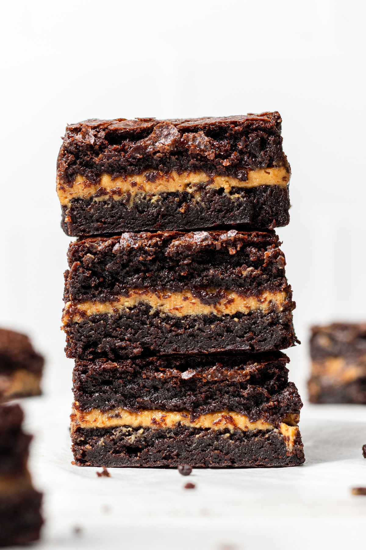 Three Chocolate Peanut Butter Brownies stacked on top of each other 