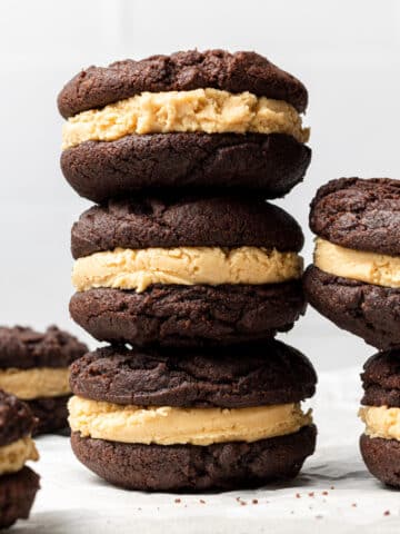 three chocolate peanut butter sandwich cookies stacked on top of each other