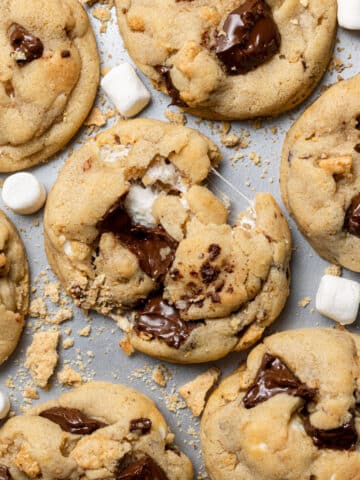 smores cookies on a tray with marshmallows scattered around