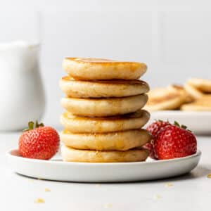 seven mini pancakes stacked on top of each other on a plate