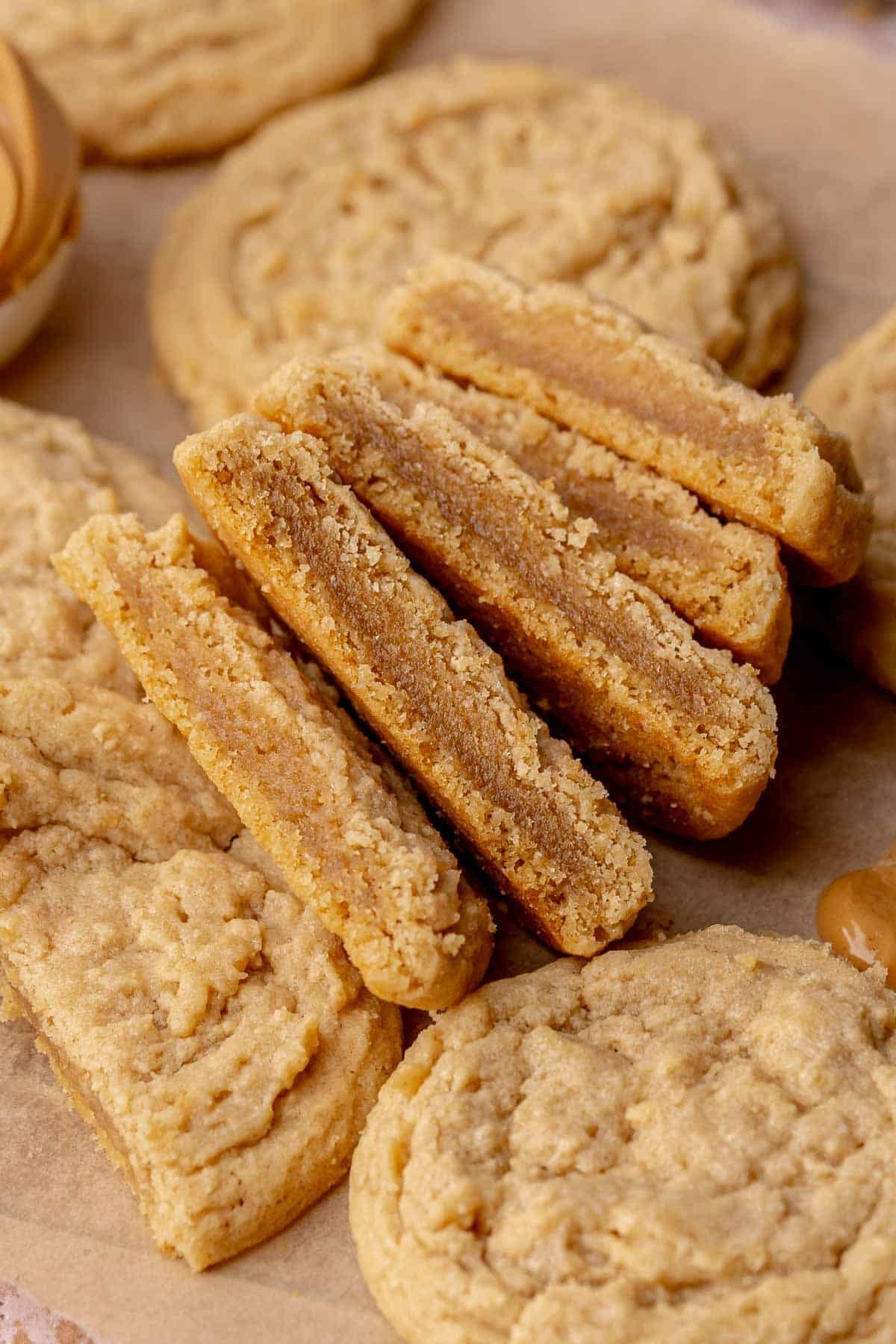 two Peanut Butter Cookies without Brown Sugar cut in half surrounded by whole cookies