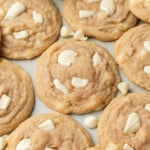 cookies arranged on a blue backdrop with white chocolate chips scattered around them.