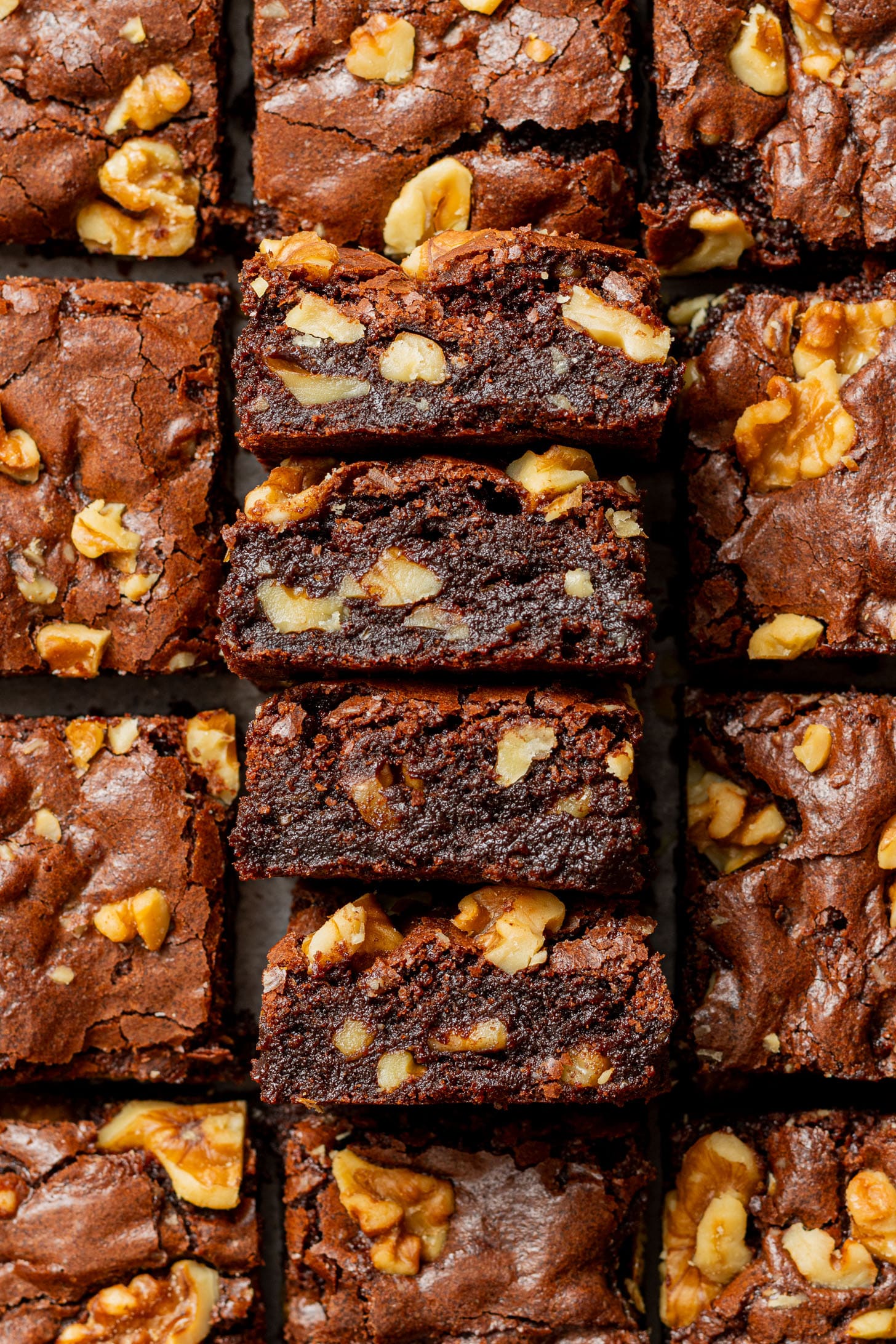 Close-up of sliced chocolate brownies topped with walnuts. The brownies have a rich, moist texture, and the walnuts add a crunchy contrast.